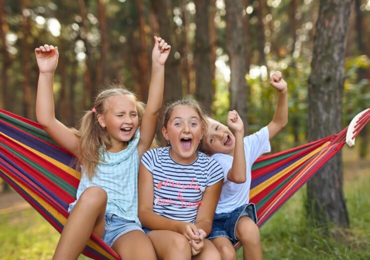 Fun in the garden kids playing in colorful hammock